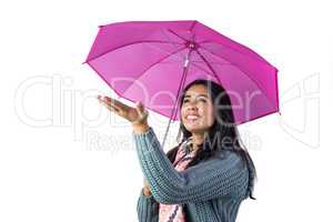 Woman checking the weather from under her umbrella