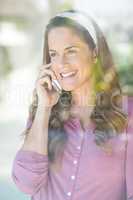 Happy woman talking on cellphone