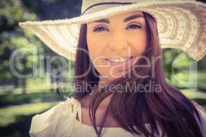 Portrait of smiling woman in sun hat