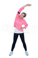 Mature woman stretching while listening music