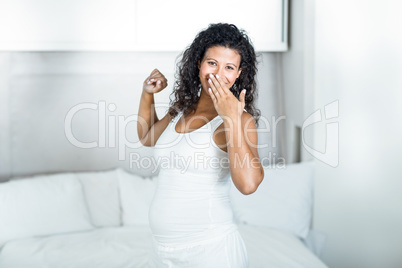 Happy lazy pregnant woman yawning
