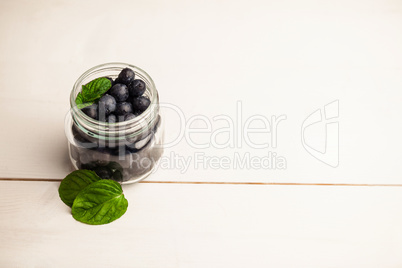 Glass jar of fresh blueberries