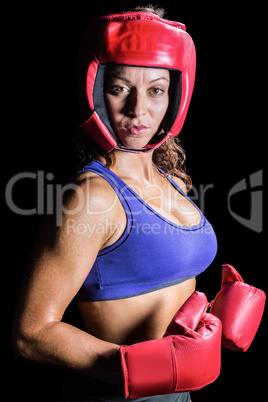 Portrait of pretty boxer with headgear and gloves
