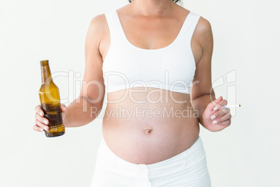 Pregnant woman holding cigarette and beer bottle