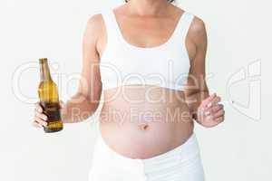 Pregnant woman holding cigarette and beer bottle