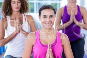 Portrait of smiling woman with joined hands