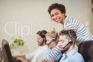 Smiling businesswoman with employees