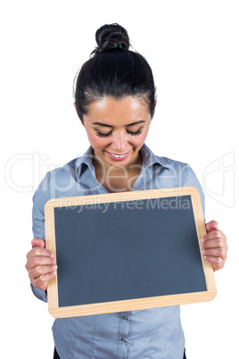 Smiling woman holding a small chalkboard