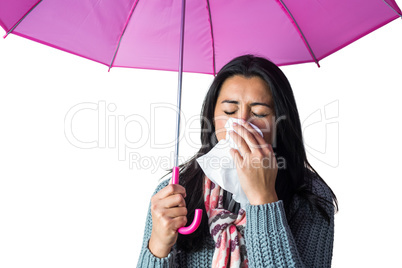 Woman sneezing into her tissue