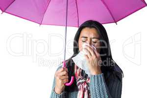 Woman sneezing into her tissue