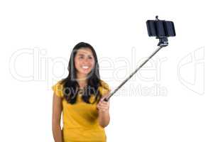 Attractive woman using a selfie stick