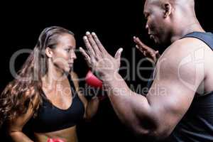 Trainer instructing female boxer