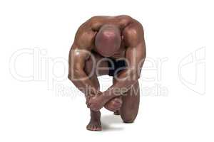 Muscular man bending on knee