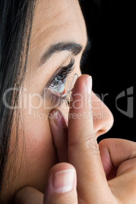Woman about to insert her contact lens