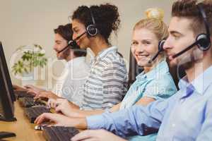 Portrait of smiling businesswoman in call center