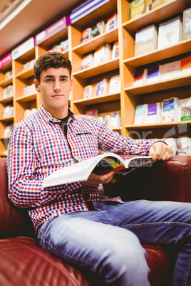 Portrait of confident young man with book