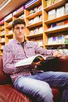 Portrait of confident young man with book