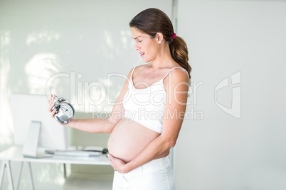 Woman frowning at alarm clock