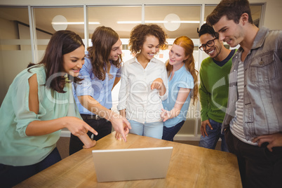 Business people pointing at laptop