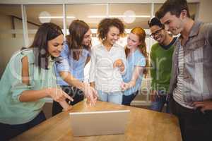 Business people pointing at laptop