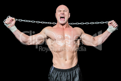 Fighter holding chain with arms raised