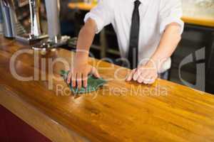 Bartender cleaning bar counter