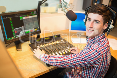 Radio host operating sound mixer
