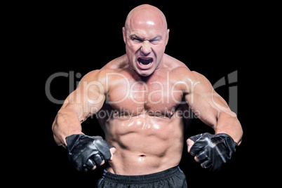 Aggressive fighter flexing muscles
