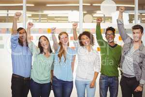Excited business people with arm raised