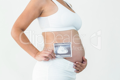 Pregnant woman holding an ultrasound scan