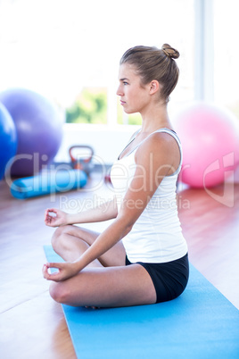 Side view of woman doing meditation