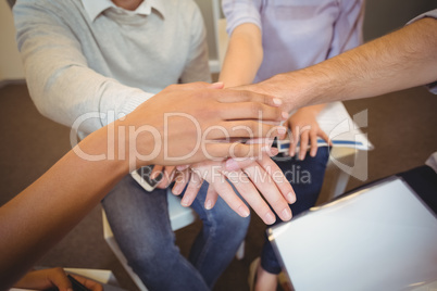 Midsection of business people with hand stack