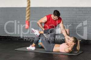 Muscular couple doing abdominal exercises