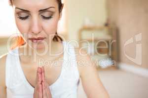 Beautiful woman meditating with joined hands