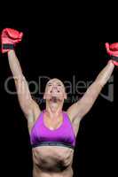 Happy female boxer with arms raised