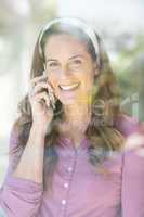 Portrait of happy woman talking on cellphone