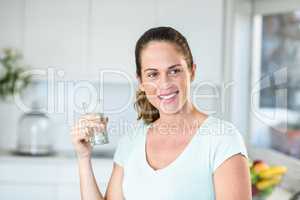 Happy woman holding water glass