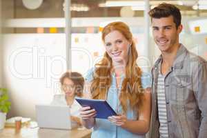 Portrait of business people holding digital PC