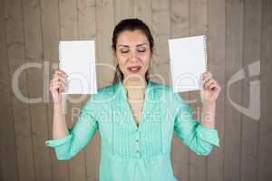 Smiling woman with eyes closed while holding papers