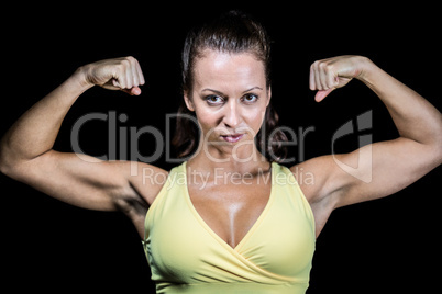 Portrait of confident athlete flexing muscles