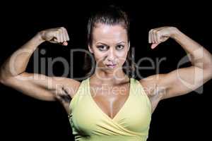 Portrait of confident athlete flexing muscles