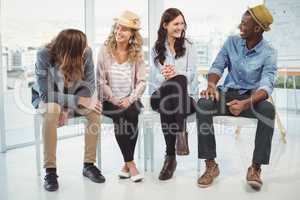 Smiling business people sitting on chair