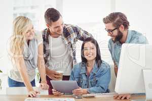 Cheerful business professionals using digital tablet