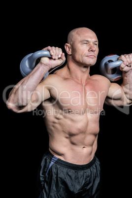 Bodybuilder lifting kettlebells