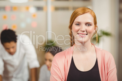 Portrait of businesswoman standing with arms crossed in office