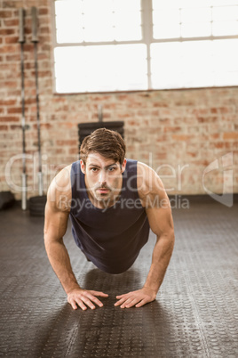 Muscular man doing diamond push ups