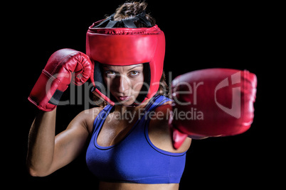 Portrait of female boxer with gloves and headgear