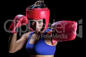 Portrait of female boxer with gloves and headgear