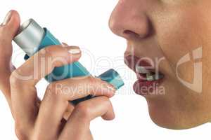 Close-up of woman face while using asthma inhaler