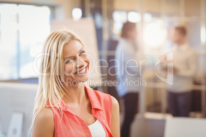 Businesswoman standing against male colleagues